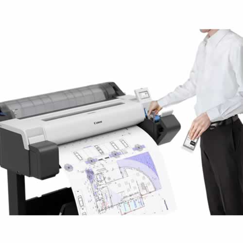 A man waiting for a CAD drawing to print on a Canon TM-340 Printer